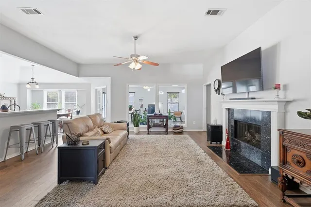a living room with furniture a fireplace and a flat screen tv