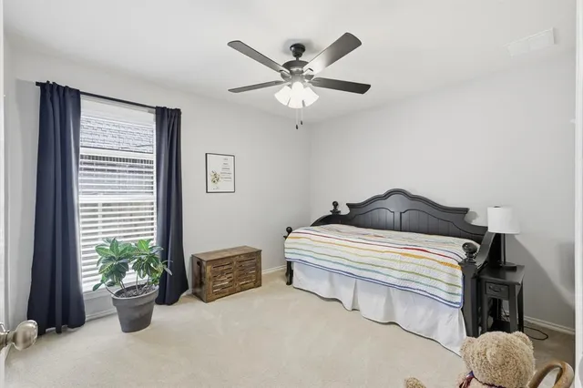 a bedroom with furniture and a window