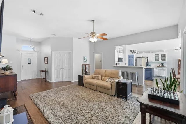 a living room with furniture and a chandelier
