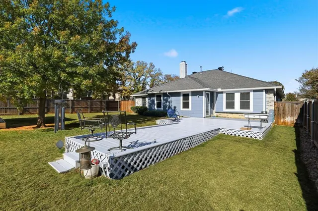 a view of a house with a yard deck and furniture