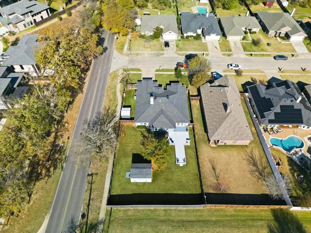an aerial view of a house with a garden and lake view