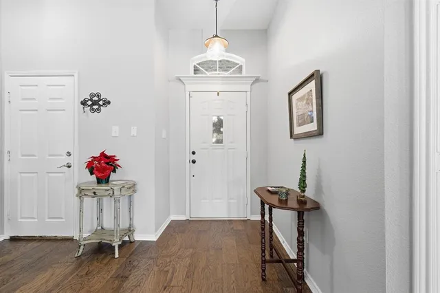 a view of a room with wooden floor and entryway