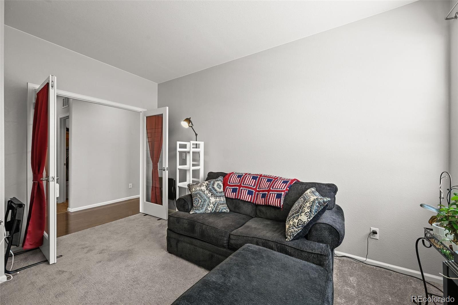 5230 Periwinkle Way Brighton, CO 80640 - Photo 16 of 44 a living room with furniture and a couch