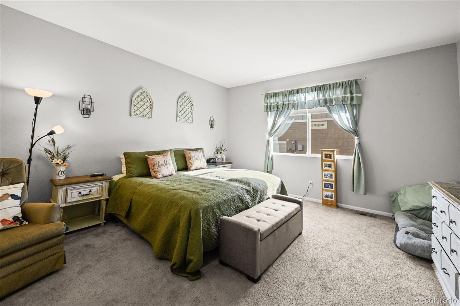 5230 Periwinkle Way Brighton, CO 80640 - Photo 17 of 44 a bedroom with a bed and a window