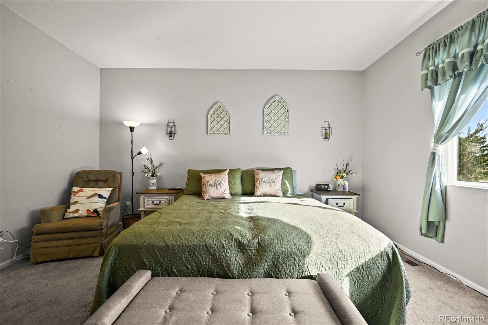 5230 Periwinkle Way Brighton, CO 80640 - Photo 18 of 44 a bedroom with a bed and a window