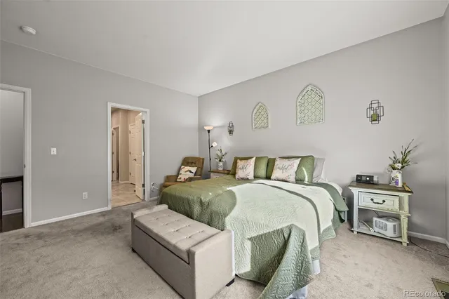 a bedroom with a bed and a couch