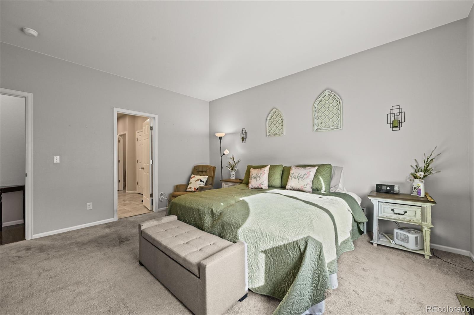 5230 Periwinkle Way Brighton, CO 80640 - Photo 19 of 44 a bedroom with a bed and a couch