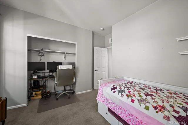 a bedroom with a bed and a chair