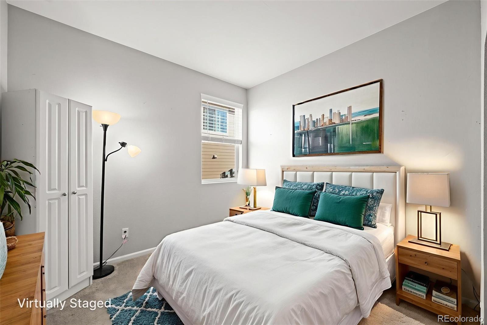 5230 Periwinkle Way Brighton, CO 80640 - Photo 26 of 44 a bedroom with a large bed and a window