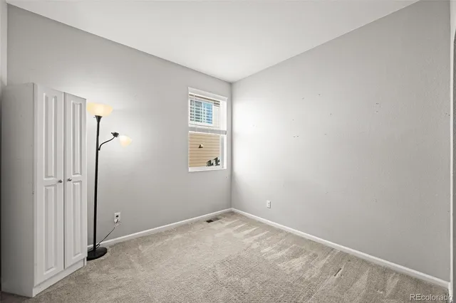 an empty room with windows and entrance