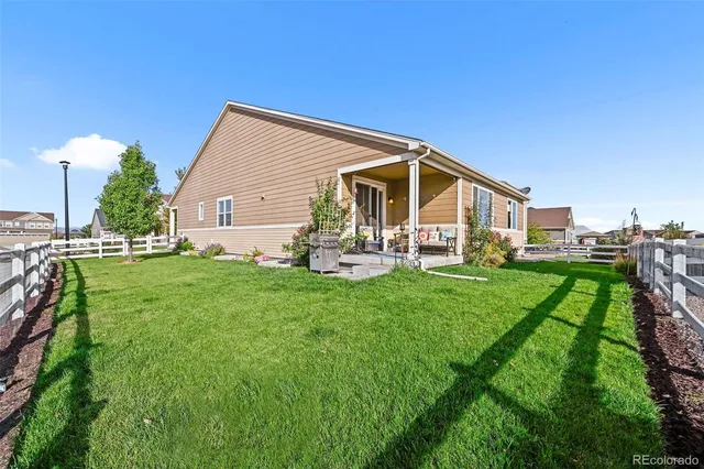 a view of a house with backyard and porch