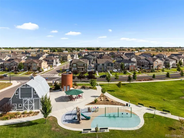 an aerial view of a house with a garden and lake view
