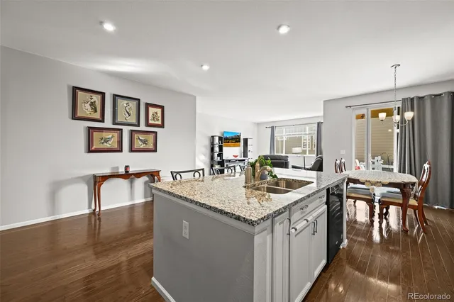a living room with granite countertop furniture and a wooden floor
