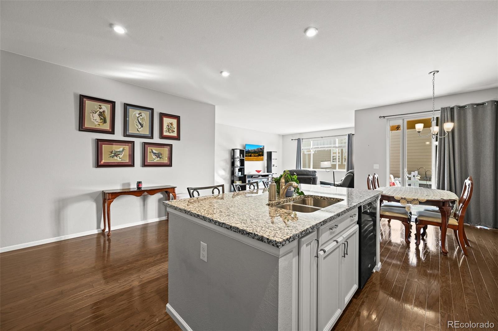 5230 Periwinkle Way Brighton, CO 80640 - Photo 6 of 44 a living room with granite countertop furniture and a wooden floor