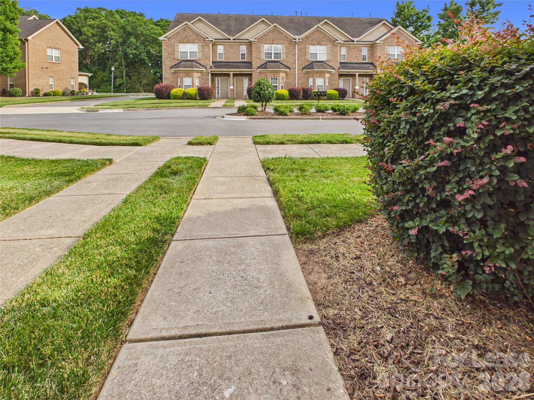 5690 Stafford Road Charlotte, NC 28215 - Photo 2 of 25 a front view of a multi story residential apartment building with yard and green space