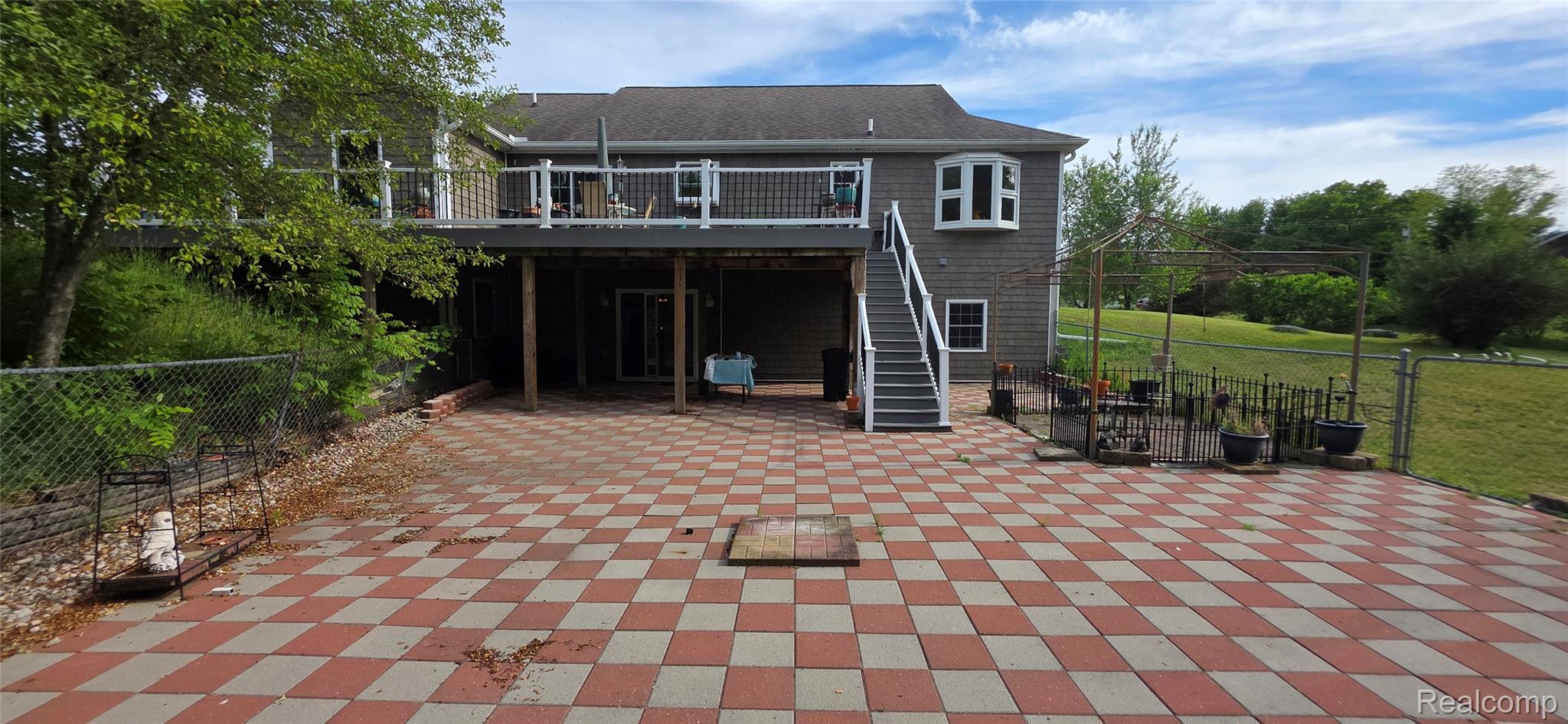 14062 Sanford Road Addison, MI 49220 - Photo 52 of 61 Expansive checkerboard-patterned patio with direct access to a second-story deck