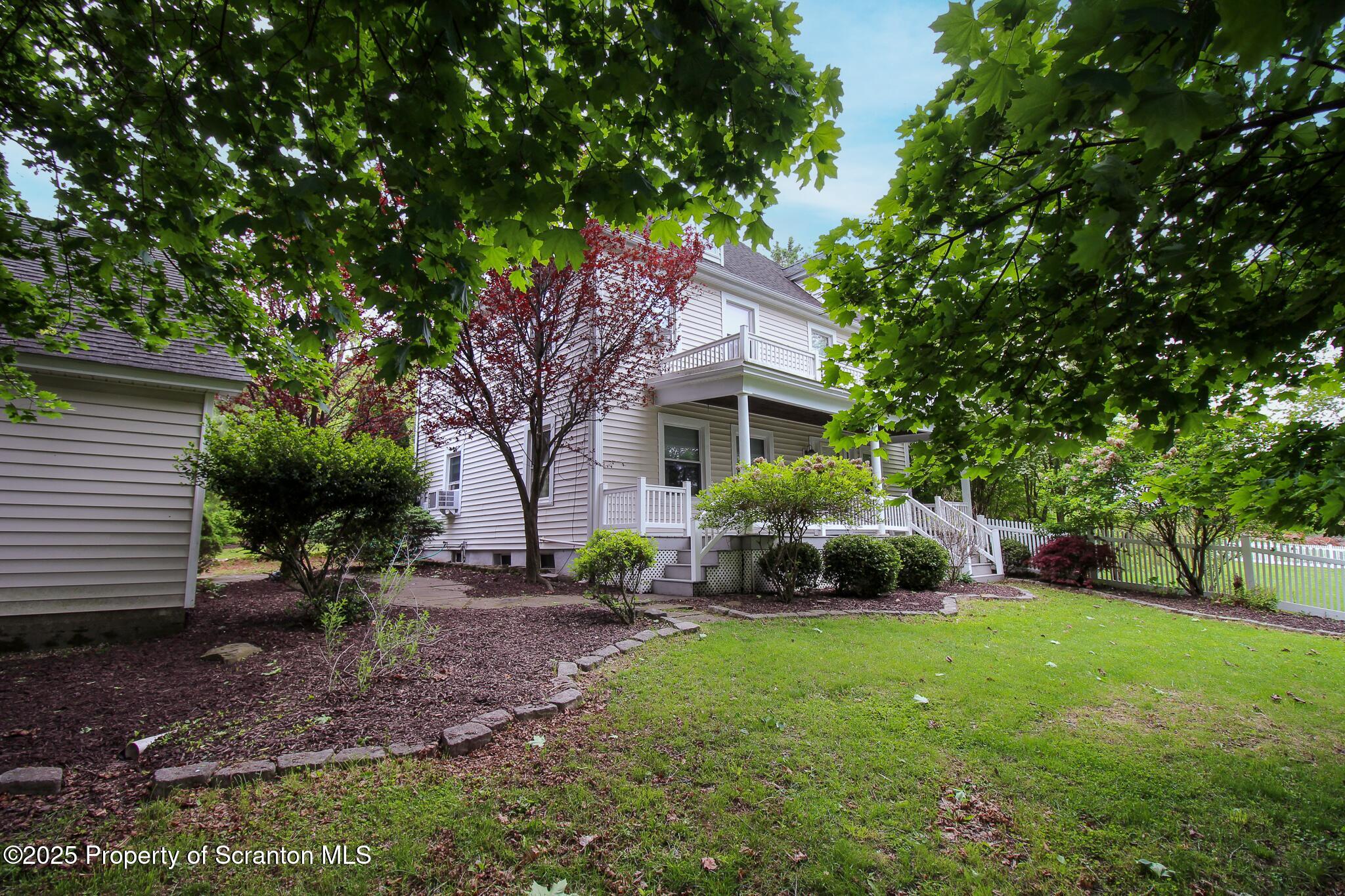 525 North Abington Road Clarks Summit, PA 18411 - Photo 41 of 61 a front view of a house with garden and trees