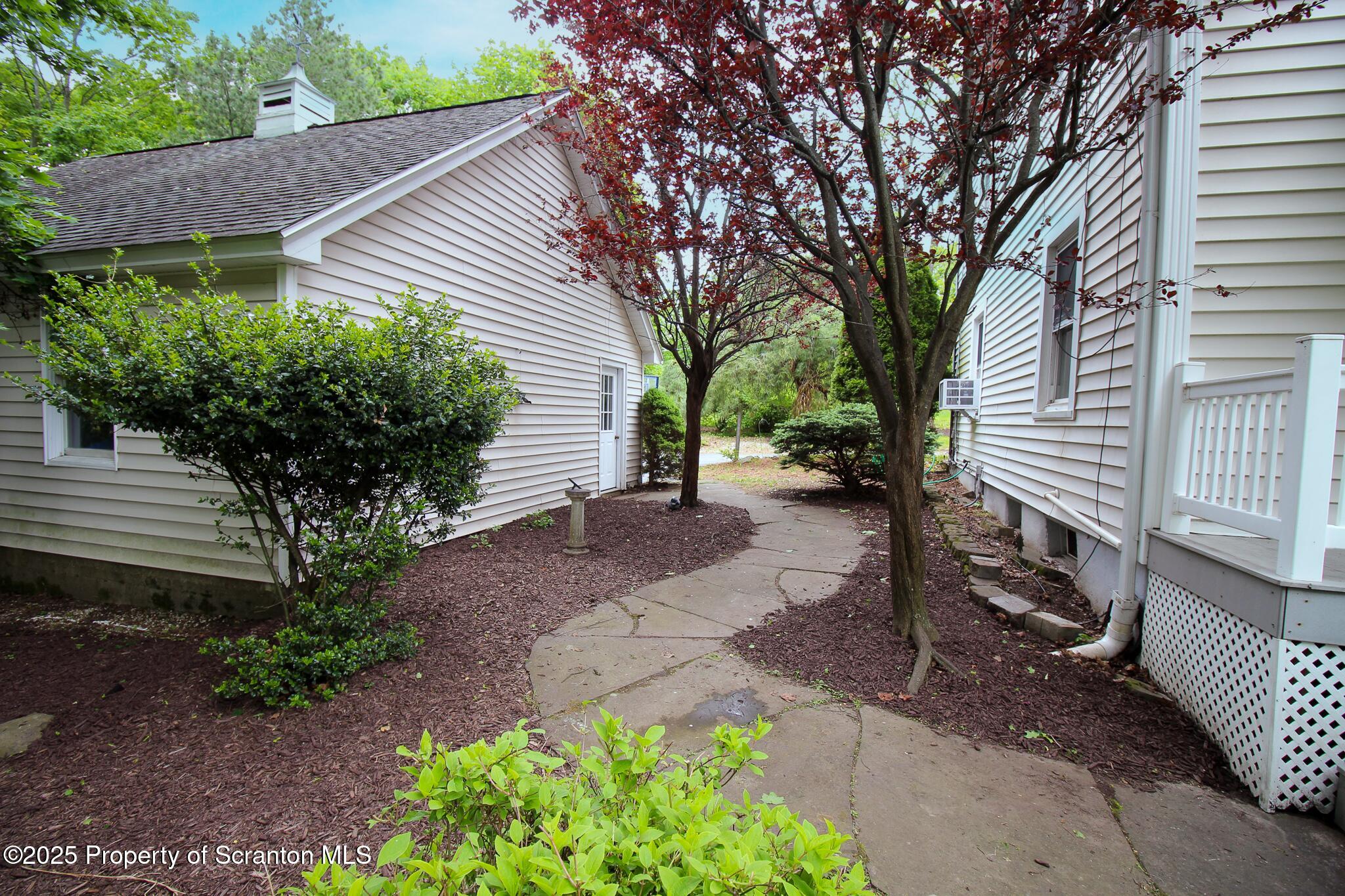 525 North Abington Road Clarks Summit, PA 18411 - Photo 42 of 61 a view of a house with a yard and a garden