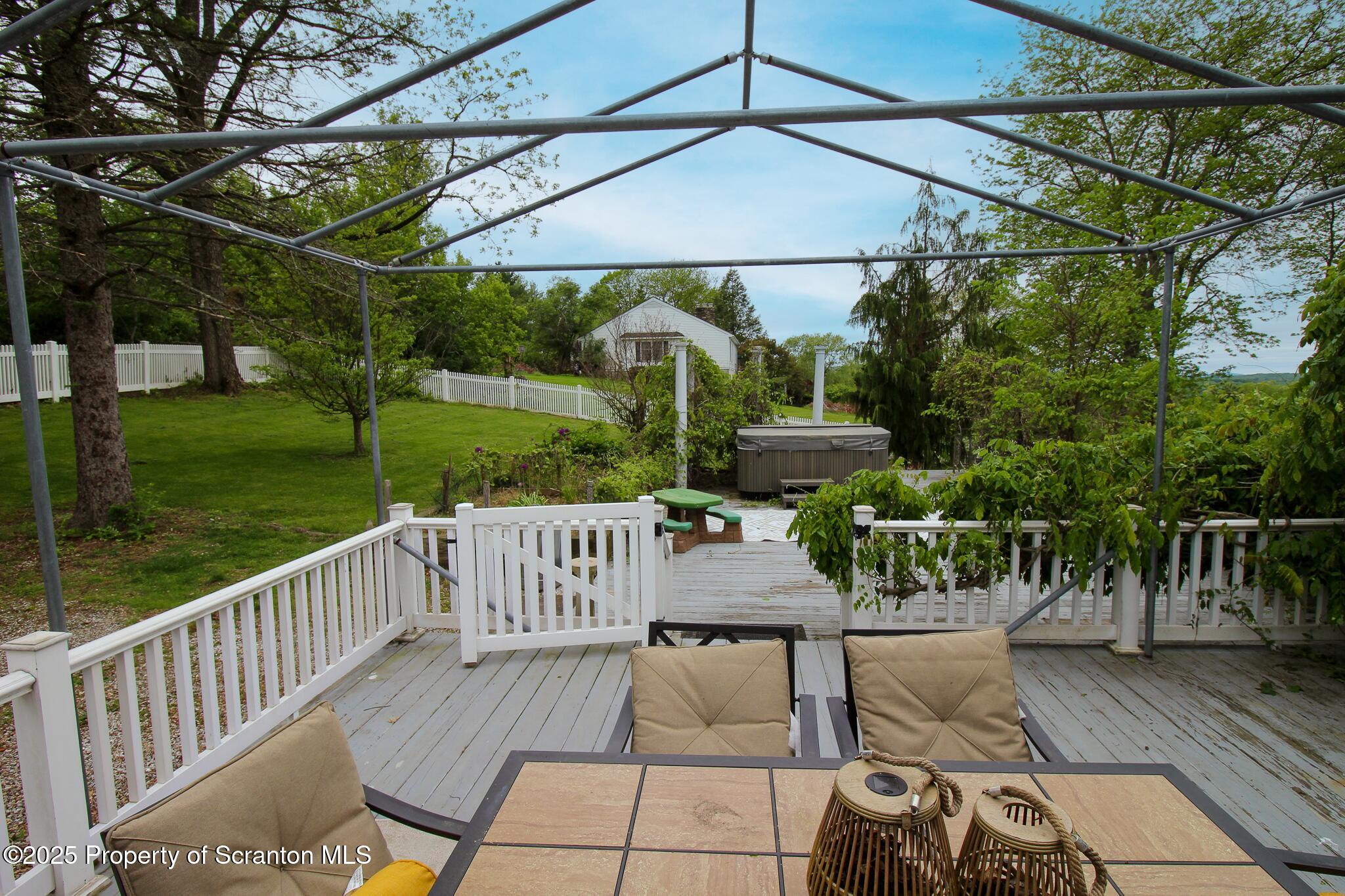 525 North Abington Road Clarks Summit, PA 18411 - Photo 55 of 61 a view of a patio with couches table and chairs under an umbrella