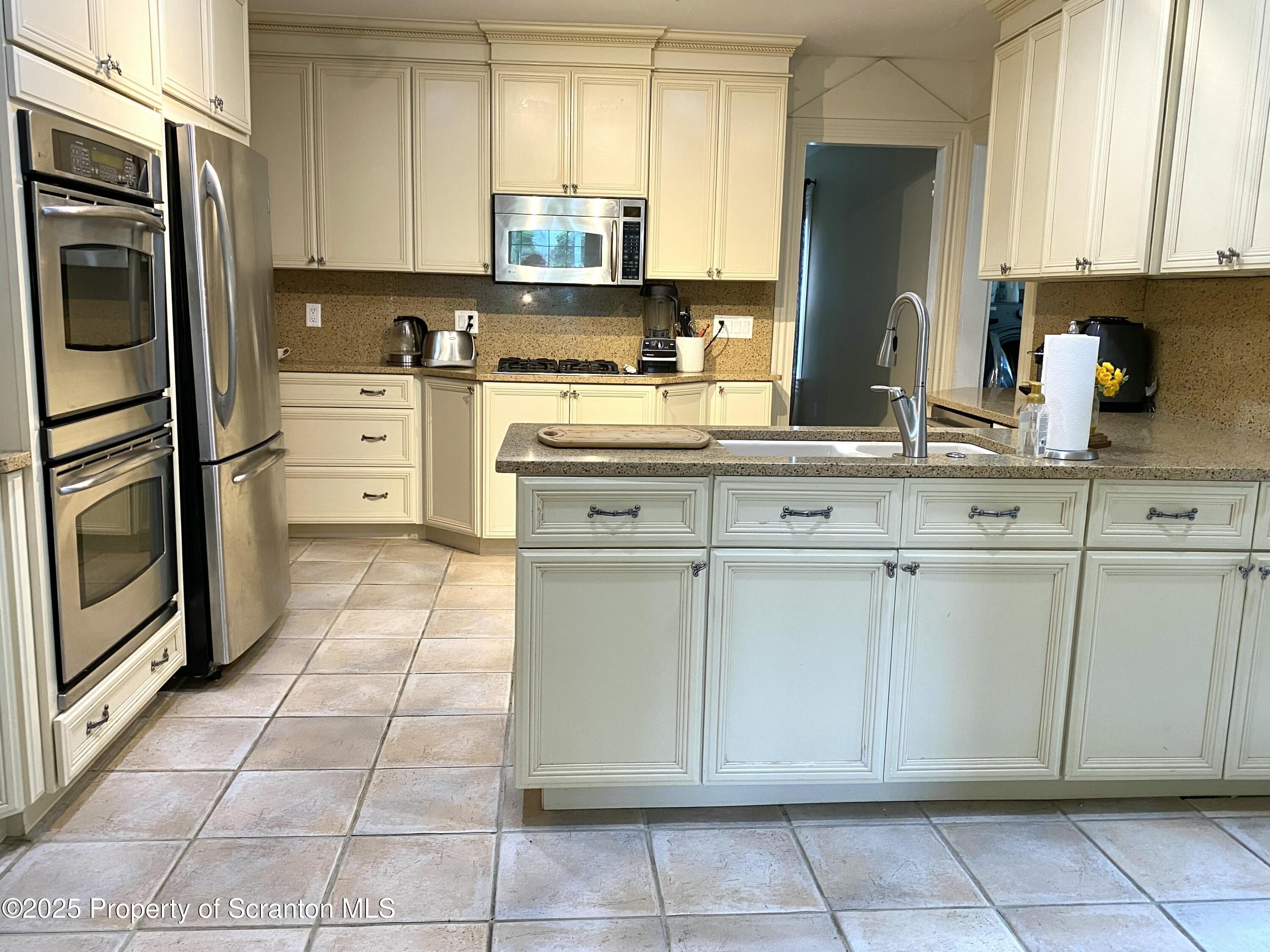 525 North Abington Road Clarks Summit, PA 18411 - Photo 7 of 61 a kitchen with cabinets and stainless steel appliances