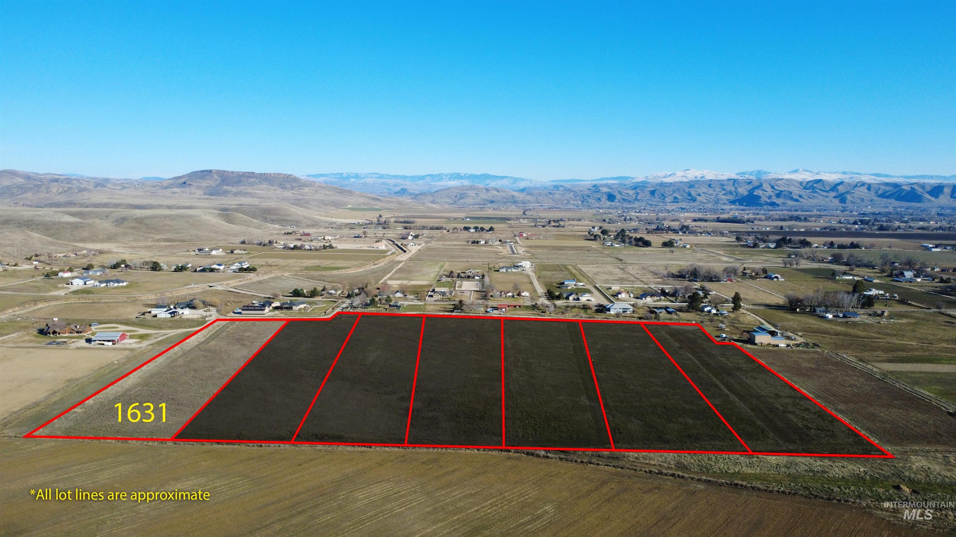 1631 Ruby Lane Emmett, ID 83617 - Photo 2 of 8 Aerial view of sparsely populated area featuring property parcel outlined and a mountain backdrop