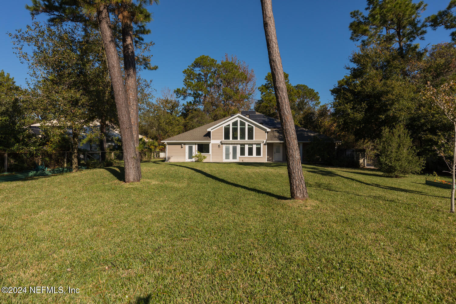 104 Loyola Road St. Augustine, FL 32086 - Photo 1 of 27 a house with trees in the background