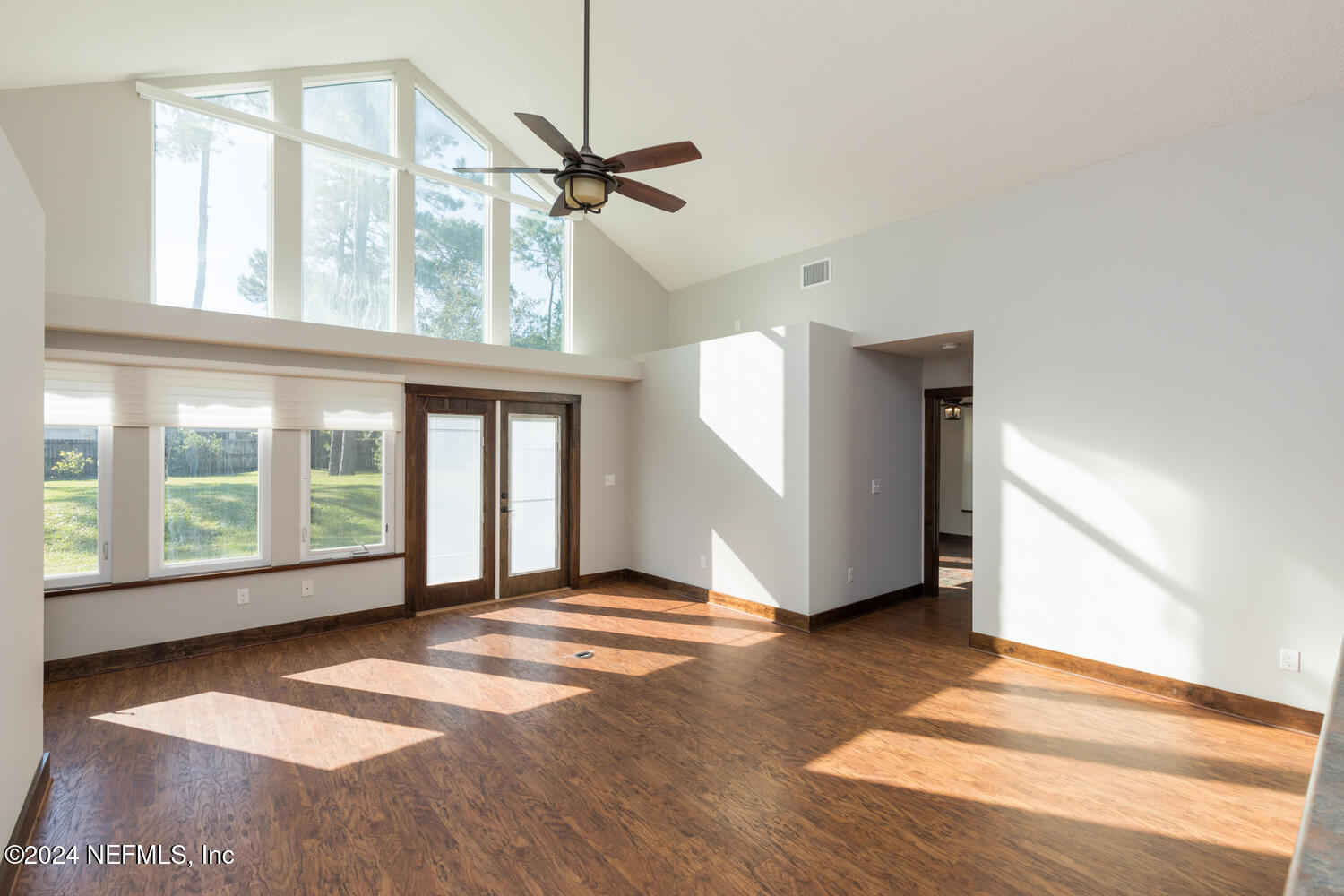 104 Loyola Road St. Augustine, FL 32086 - Photo 13 of 27 a view of an empty room with a window and wooden floor