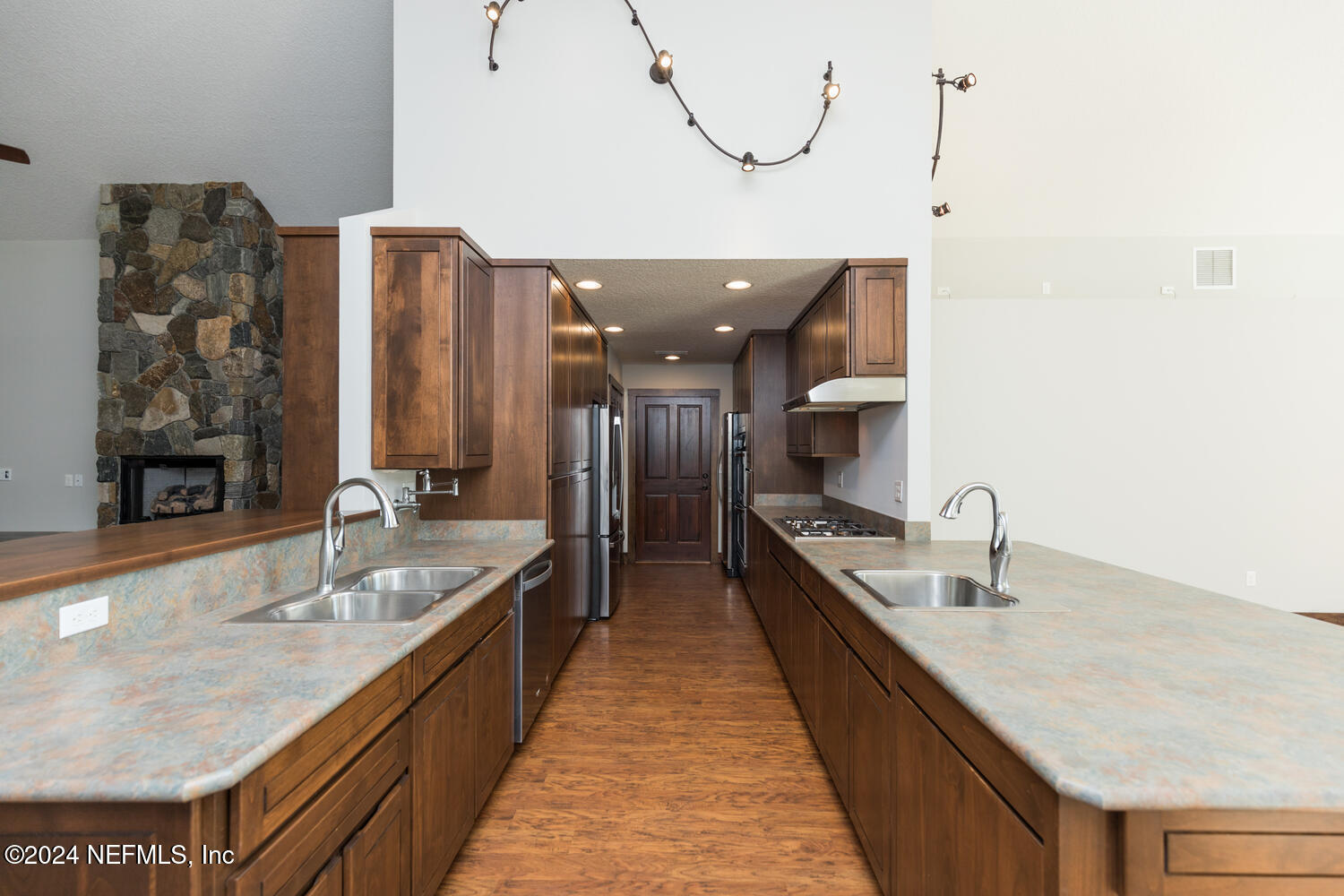 104 Loyola Road St. Augustine, FL 32086 - Photo 16 of 27 a large kitchen with a large counter top a sink and stainless steel appliances