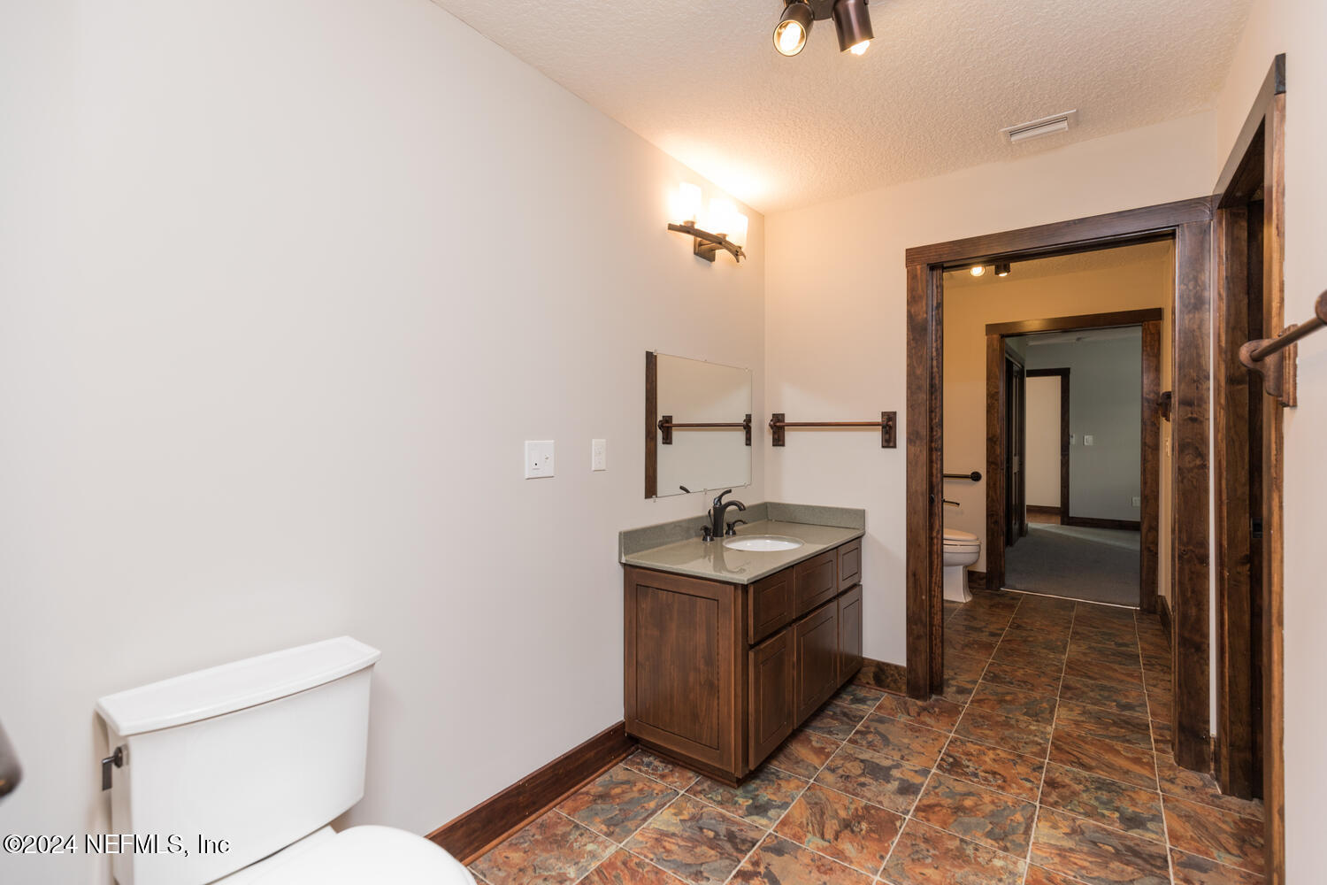 104 Loyola Road St. Augustine, FL 32086 - Photo 21 of 27 a bathroom with a toilet a sink and mirror
