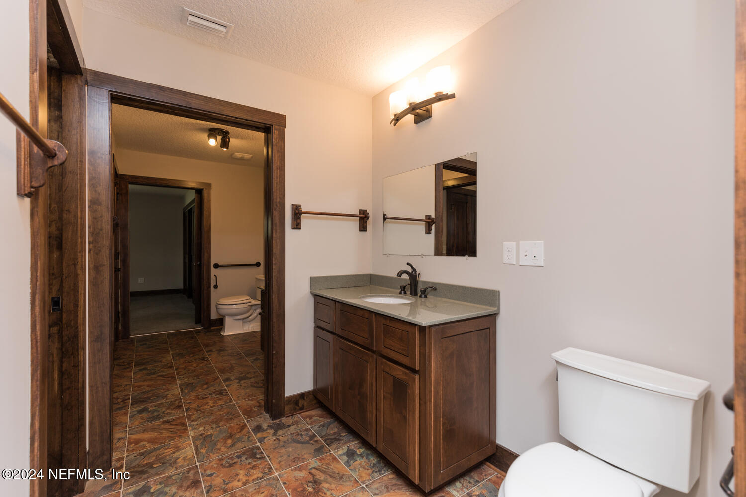 104 Loyola Road St. Augustine, FL 32086 - Photo 22 of 27 a bathroom with a toilet sink and mirror