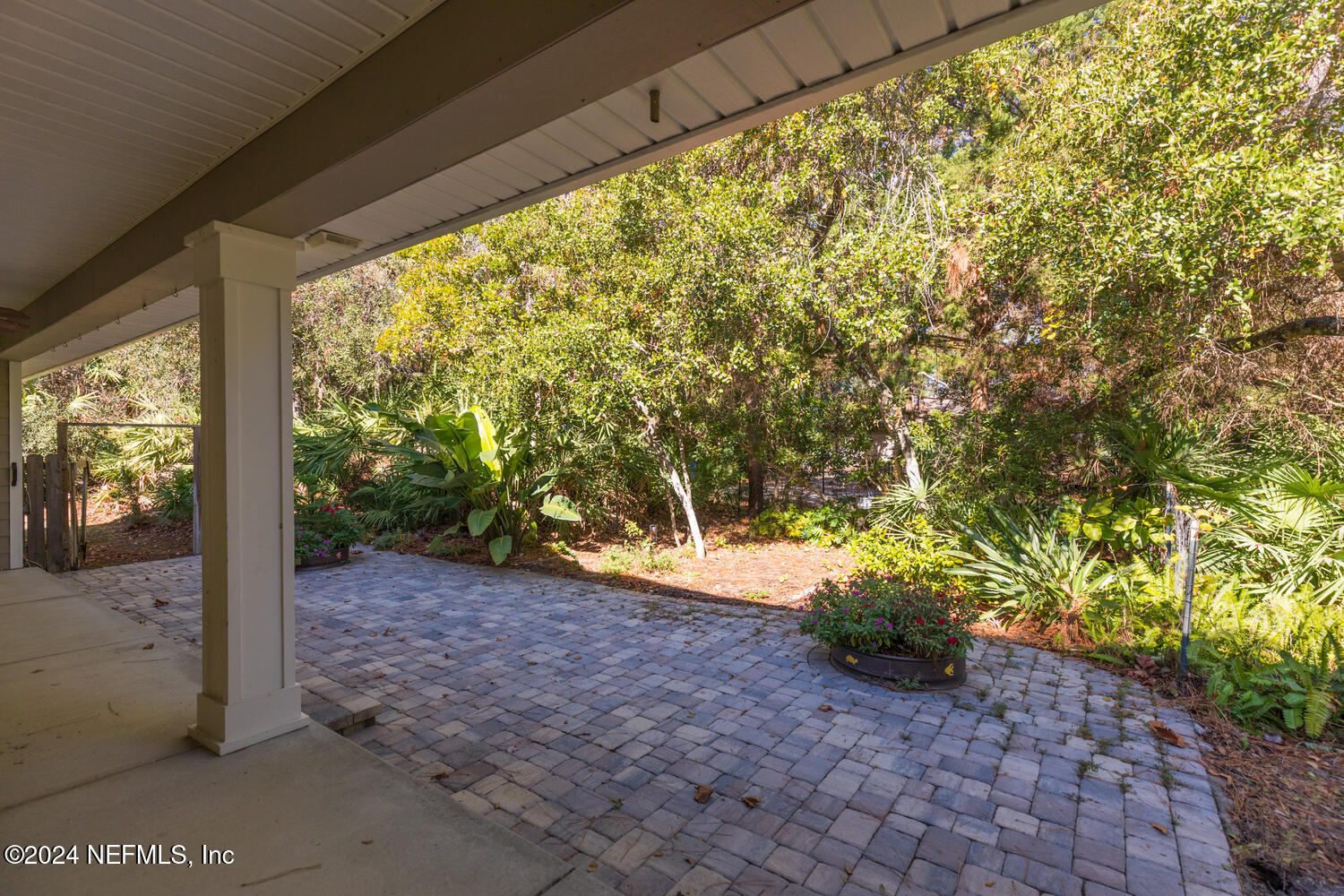 104 Loyola Road St. Augustine, FL 32086 - Photo 4 of 27 a view of a garden with plants and wooden fence