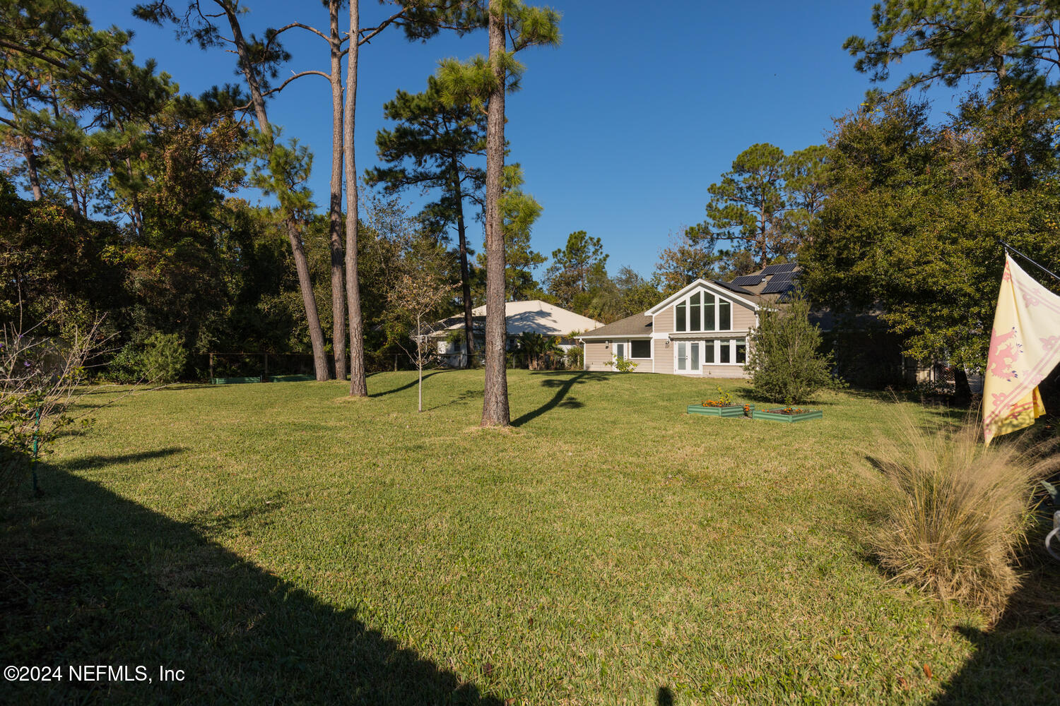 104 Loyola Road St. Augustine, FL 32086 - Photo 6 of 27 a yellow and white house with a yard