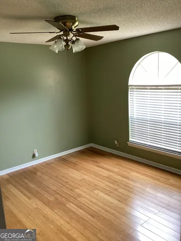 a view of a room with a window and a ceiling fan