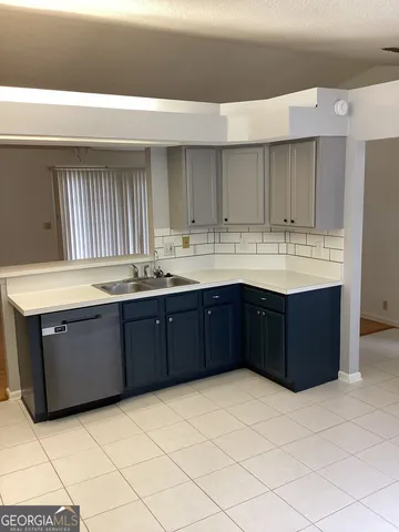 a kitchen with a sink and cabinets