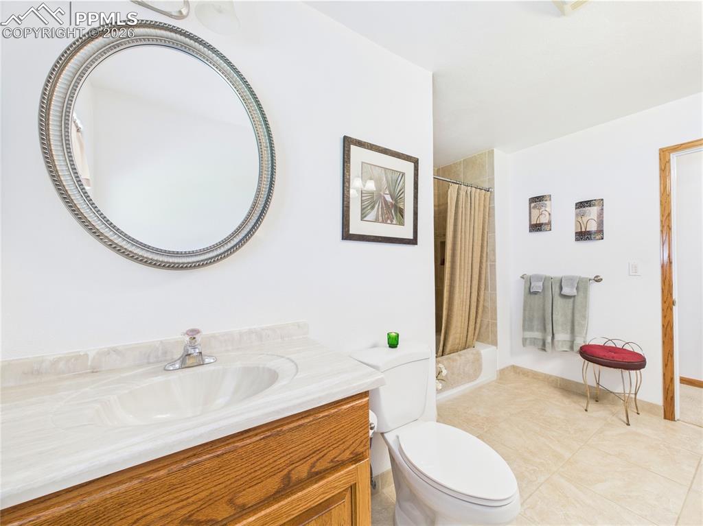 32006 Ford Road Pueblo, CO 81006 - Photo 24 of 50 a bathroom with a toilet a sink and a mirror