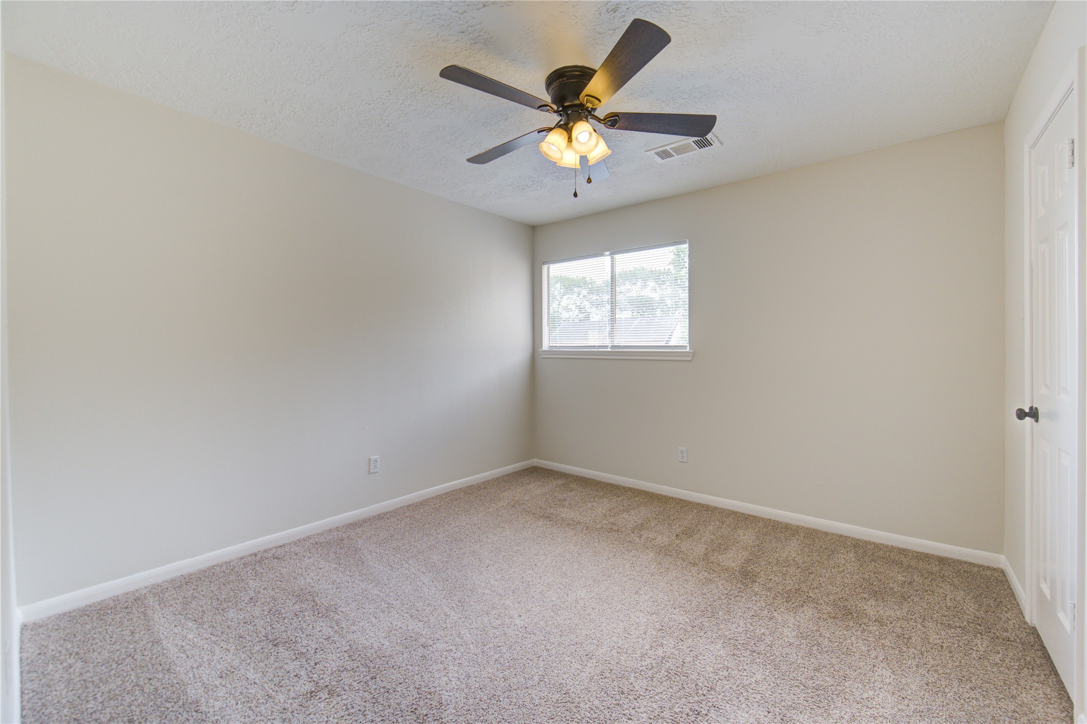 9115 Taidswood Drive Spring, TX 77379 - Photo 28 of 45 Bedroom 3 - All bedrooms have lighted ceiling fans, neutral paint and carpeting, and large walk-in closets!