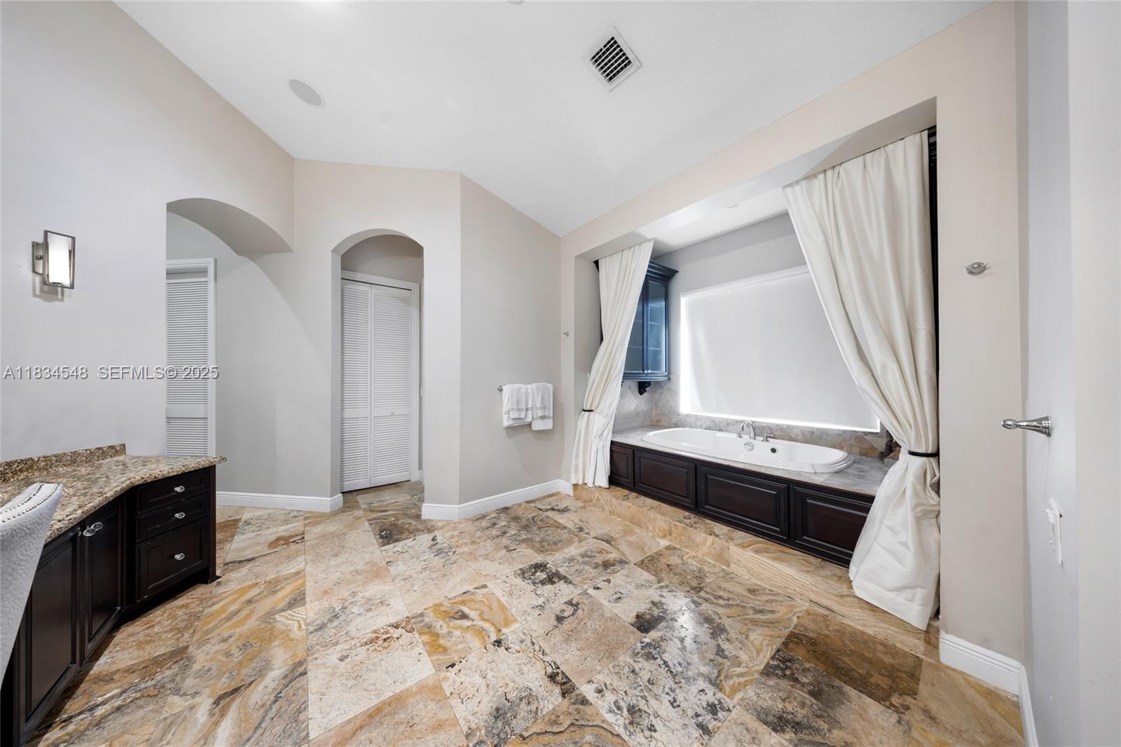 16701 Southwest 49th Street Southwest Ranches, FL 33331 - Photo 39 of 56 a spacious bedroom with a bed and a dresser