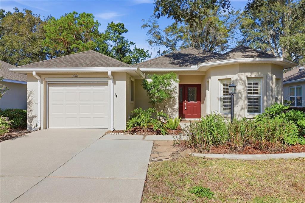 6301 West Glynborne Loop Crystal River, FL 34429 - Photo 1 of 63 front view of a house with potted plants
