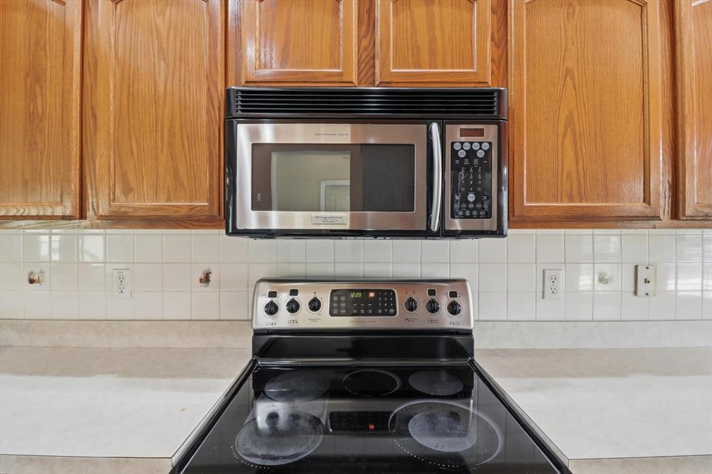 6301 West Glynborne Loop Crystal River, FL 34429 - Photo 25 of 63 a kitchen with granite countertop wood cabinets and a stove