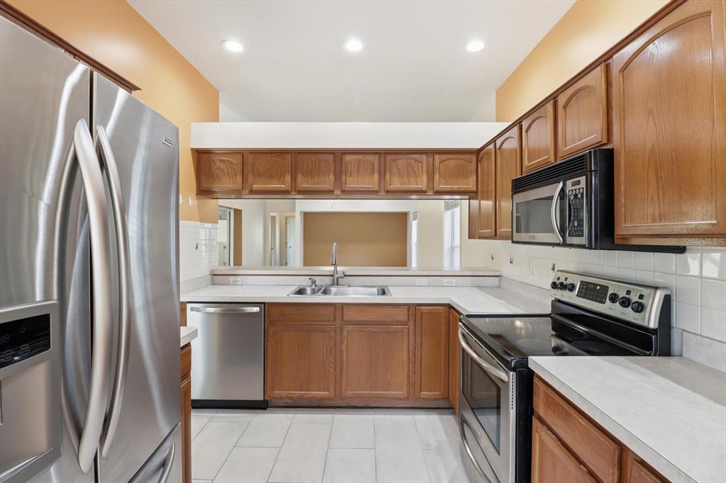 6301 West Glynborne Loop Crystal River, FL 34429 - Photo 3 of 63 a kitchen with stainless steel appliances granite countertop a stove top oven a sink and a refrigerator