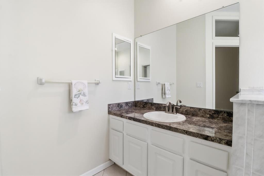 6301 West Glynborne Loop Crystal River, FL 34429 - Photo 34 of 63 a bathroom with a granite countertop sink and a mirror