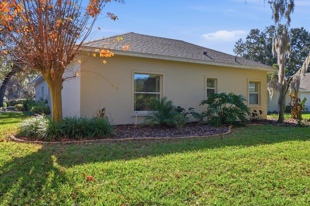 6301 West Glynborne Loop Crystal River, FL 34429 - Photo 44 of 63 a view of a house with a yard and potted plants