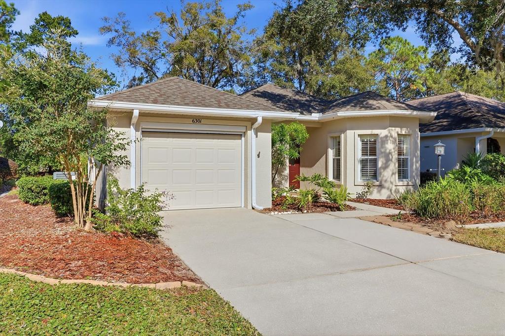 6301 West Glynborne Loop Crystal River, FL 34429 - Photo 9 of 63 a front view of a house with garden