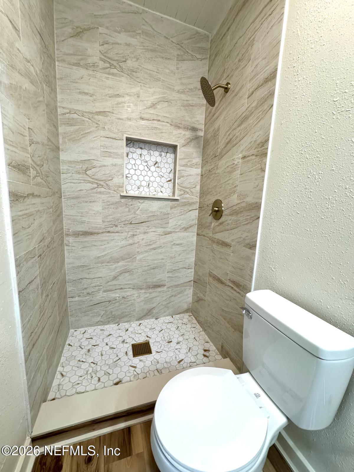 2774 Fitzgerald Street Jacksonville, FL 32254 - Photo 12 of 15 a bathroom with a toilet and a shower