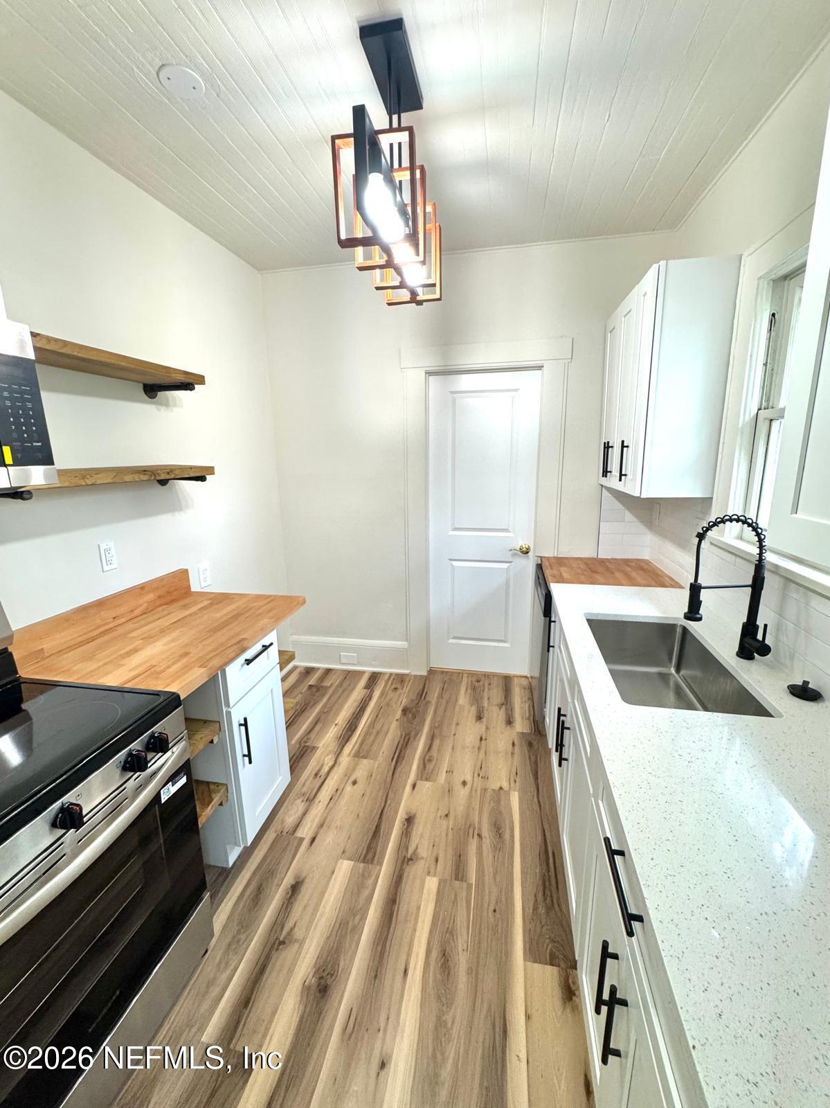 2774 Fitzgerald Street Jacksonville, FL 32254 - Photo 6 of 15 a kitchen with a stove and a sink