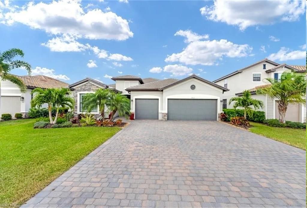 a front view of a house with a yard and garage