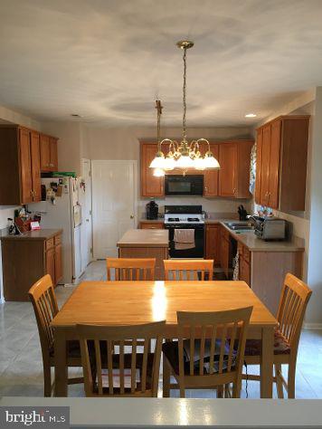 42 Hill Road Warminster, PA 18974 - Photo 15 of 44 a large kitchen with a table chairs stove and refrigerator