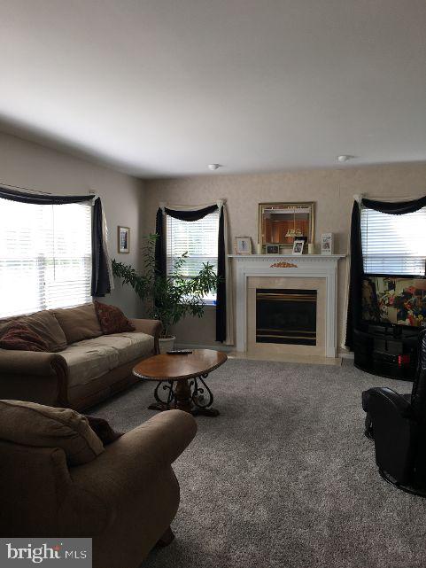 42 Hill Road Warminster, PA 18974 - Photo 18 of 44 a living room with furniture a flat screen tv and a fireplace