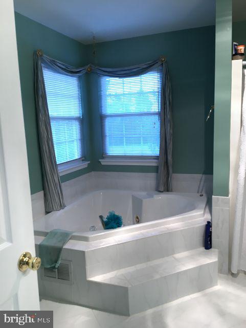 42 Hill Road Warminster, PA 18974 - Photo 28 of 44 a bathroom with a bathtub and a window