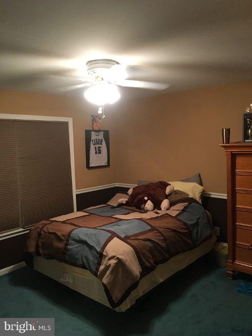 42 Hill Road Warminster, PA 18974 - Photo 30 of 44 a bedroom with a bed and a chandelier